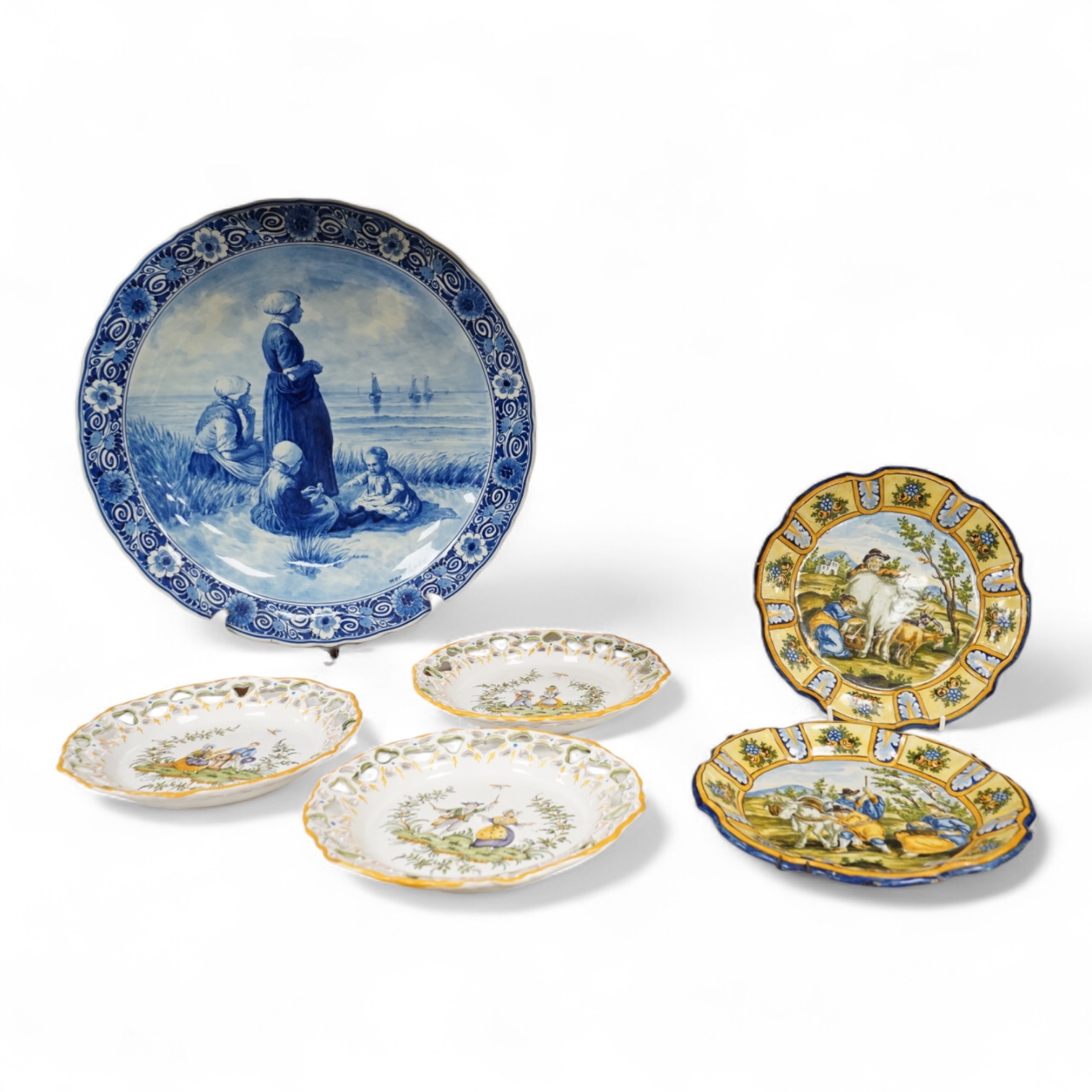 A Delft charger after Artz, together with other faience and majolica dishes, largest 41cm diameter (6)